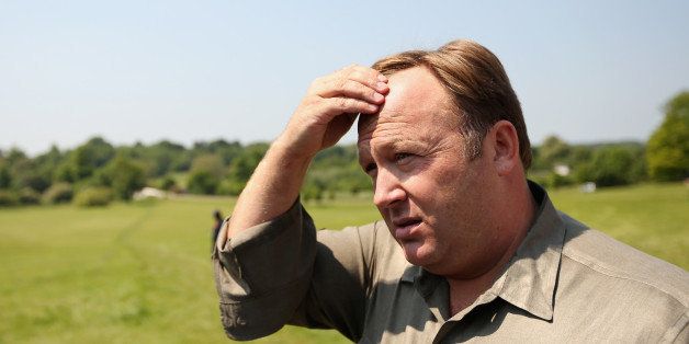 WATFORD, ENGLAND - JUNE 06: Alex Jones, an American radio host, author and conspiracy theorist, addresses media and protesters in the protester encampment outside The Grove hotel, which is hosting the annual Bilderberg conference, on June 6, 2013 in Watford, England. The traditionally secretive conference, which has taken place since 1954, is expected to be attended by politicians, bank bosses, billionaires, chief executives and European royalty. (Photo by Oli Scarff/Getty Images)