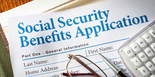 Social Security Benefits form with pen, glasses, and calculator