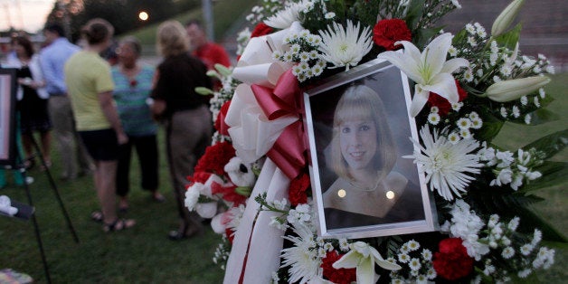 MARTINSVILLE, VA - AUGUST 27: A photo sits amonst flowers at a candlelight vigil for Alison Parker on Martinsville High School's football field on August 27, 2015 in Martinsville, Virginia. Two employees of WDBJ TV were killed during a live broadcast at Bridgewater Plaza on Smith Mountain Lake on August 26. The victims have been identified as reporter Alison Parker and cameraman Adam Ward. Parker, 24 and Ward, 27, worked for WDBJ in Roanoke, Virginia. The suspect, Vester Lee Flanigan, also known as Bryce Williams, died of a self-inflicted gunshot wound. (Photo by Jay Paul/Getty Images)