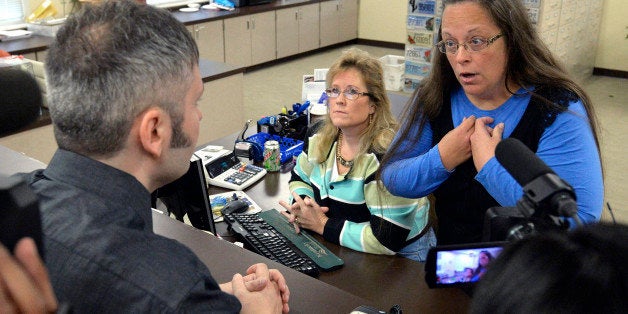 Rowan County Clerk Kim Davis, right, talks with David Moore following her office's refusal to issue marriage licenses at the Rowan County Courthouse in Morehead, Ky., Tuesday, Sept. 1, 2015. Although her appeal to the U.S. Supreme Court was denied, Davis still refuses to issue marriage licenses. (AP Photo/Timothy D. Easley)