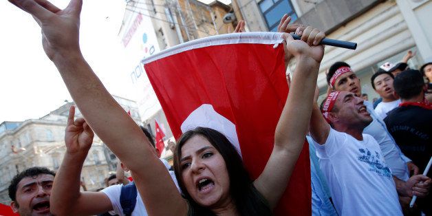 A group of Turkish nationalists chant slogans, protesting against against Kurdistan Workers' Party (PKK) militants' recent attacks on Turkish security forces, during a march in Istanbul, Sunday, Aug. 16, 2015. There had been a sharp escalation of violence lately between Turkey's security forces and the PKK and the collapse of a two-year peace process with the rebels. Dozens of people, mostly Turkish soldiers, have died since July in the renewed violence. (AP Photo/Emrah Gurel)