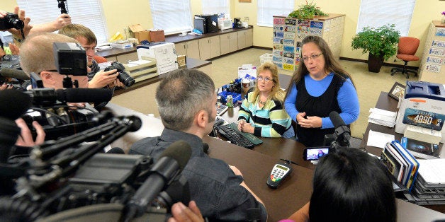 Rowan County Clerk Kim Davis, right, talks with David Moore following her office's refusal to issue marriage licenses at the Rowan County Courthouse in Morehead, Ky., Tuesday, Sept. 1, 2015. Although her appeal to the U.S. Supreme Court was denied, Davis still refuses to issue marriage licenses. (AP Photo/Timothy D. Easley)