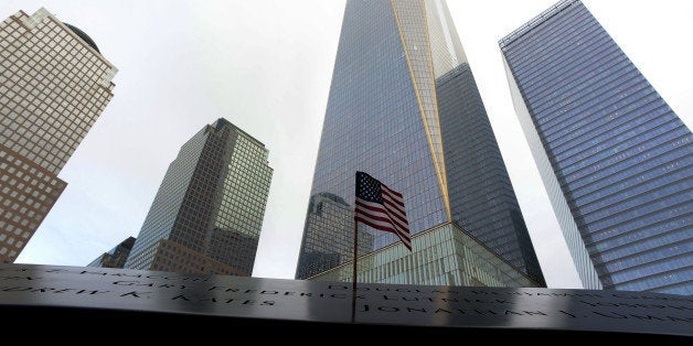 An American flag marks the name of a loved one at the North Pool Memorial site in front of 1 World Trade Center during memori