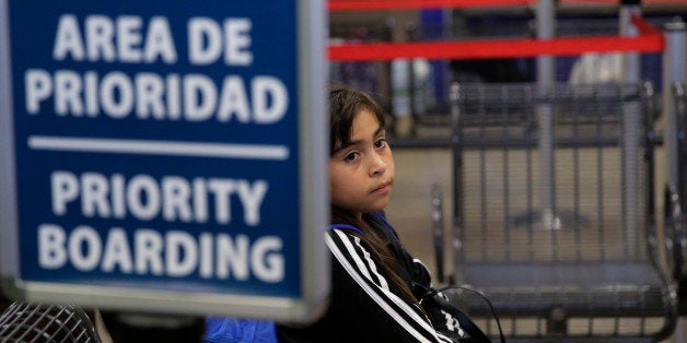 An immigrant from Guatemala who entered the country illegally waits at a bus station she and others were released from a fami