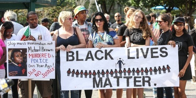 NEW YORK, NY - AUGUST 09: People hold banners reading 'Black Lives Matter' during a rally to mark the one year anniversary of