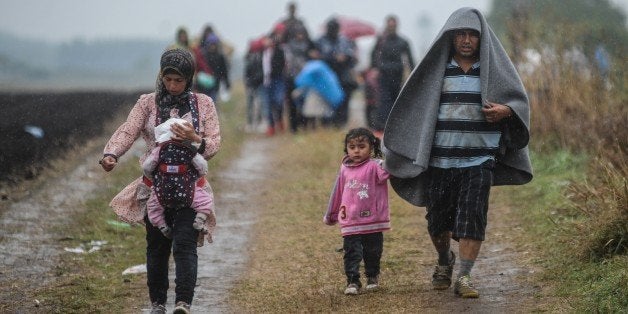 ROSZKE, HUNGARY- SEPTEMBER 10: Refugees arrive at a makeshift camp for asylum seekers near the border line between Serbia and
