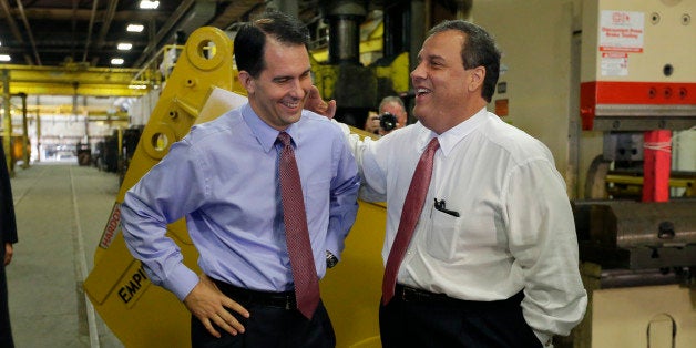 New Jersey Gov. Chris Christie, right, and Wisconsin Gov. Scott Walker share a laugh as Walker campaigns at Empire Bucket in Hudson, Wis., Monday, Sept. 29, 2014. (AP Photo/Ann Heisenfelt)