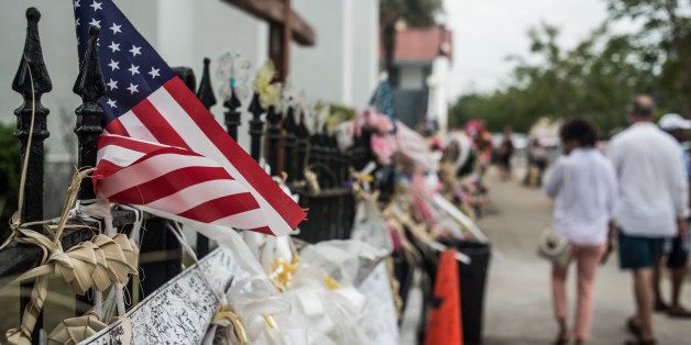 CHARLESTON, SC - JULY 31: People walk past Emanuel AME Church JULY 31, 2015 in Charleston, South Carolina. Earlier in the morning, Dylann Roof, the shooter in the June 17 massacre was arraigned on 33 federal charges, including hate crimes. (Photo by Sean Rayford/Getty Images)