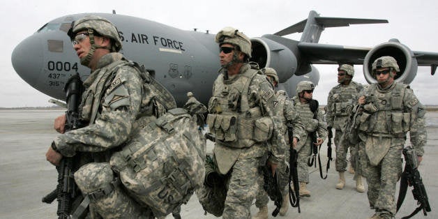 US soldiers arrived from Afghanistan walk outside a plane at the US airbase 30 km outside Bishkek in Manas on February 26, 20