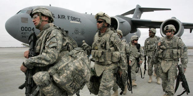 US soldiers arrived from Afghanistan walk outside a plane at the US airbase 30 km outside Bishkek in Manas on February 26, 2009. The soldiers who had been serving with ISAF forces in Afghanistan made a layover on their way to Germany. The United States is still holding out hope for a deal with Kyrgyzstan to avoid the closure of the US military supply base there for Afghanistan even after the Kyrgyz president formalised the shutdown. AFP PHOTO / VYACHESLAV OSELEDKO (Photo credit should read VYACHESLAV OSELEDKO/AFP/Getty Images)