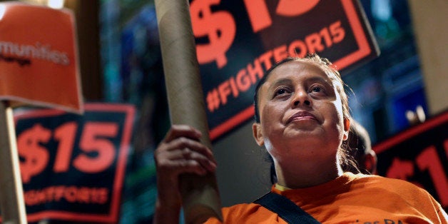 Demonstrators rally for a $15 minimum wage before a meeting of the wage board in New York, Monday, June 15, 2015. The board, created by Gov. Andrew Cuomo, will consider a minimum wage increase for New York's fast-food workers. (AP Photo/Seth Wenig)