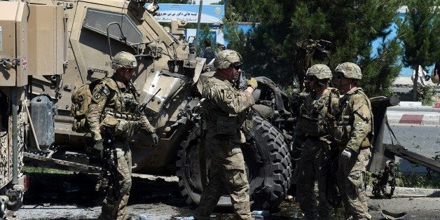 NATO soldiers arrive at the scene of a suicide car bomb attack that targeted foreign military vehicles in Kabul on June 30,2015. A powerful blast hit downtown Kabul on June 30 as a suicide car bomber targeted foreign military vehicles, officials said, with casualties feared. The blast came on the main road to the airport, around 500 meters (550 yards) from the US embassy and near a base for foreign troops.'It was a suicide car bomber targeting a convoy of foreign forces in Kabul,' interior ministry spokesman Sediq Sediq said. AFP PHOTO / Wakil Kohsar (Photo credit should read WAKIL KOHSAR/AFP/Getty Images)