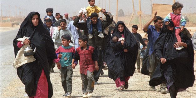 Baghdad, Iraq; April 5, 2003. Iraqi civilians abandon the outer suburbs of Baghdad on foot carrying the few belongings they can while US Marines advance on the Iraqi capital to confront the last remaining troops loyal to Saddam Husein.
