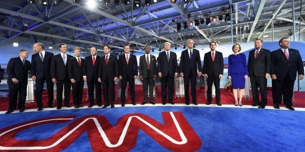 Republican presidential hopefuls, (L-R) South Carolina Sen. Lindsay Graham, former New York Gov. George Pataki, Sen. Rick Santorum, Kentucky Sen. Rand Paul, former Arkansas Gov. Mike Huckabee, Florida Sen. Marco Rubio, Texas Sen. Ted Cruz, retired neurosurgeon Ben Carson, real estate magnate Donald Trump, former Florida Gov. Jeb Bush, Wisconsin Gov. Scott Walker, former CEO Carly Fiorina, Ohio Gov. John Kasich, and New Jersey Gov. Chris Christie, arrive on stage for the Republican presidential debate at the Ronald Reagan Presidential Library in Simi Valley, California on September 16, 2015. Republican presidential candidates collectively turned their sights on frontrunner Donald Trump at the party's second debate, taking aim at his lack of political experience and his sometimes abrasive style. AFP PHOTO/ ROBYN BECK (Photo credit should read ROBYN BECK/AFP/Getty Images)