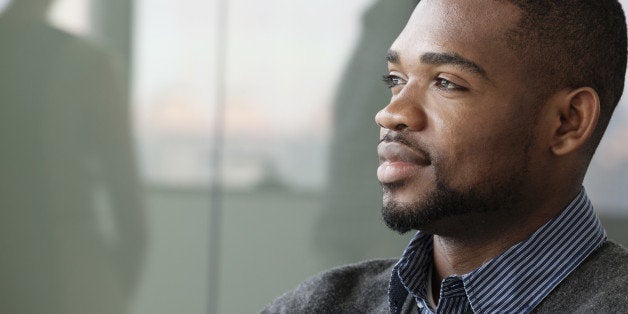 Portrait of young smiling businessman looking away