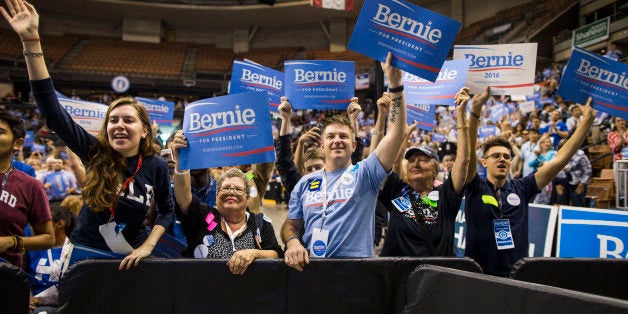 MANCHESTER, NH - SEPTEMBER 19: Supporters of democratic presidential candidate Senator Bernie Sanders (I-VT) hold up signs while he talks on stage during the New Hampshire Democratic Party State Convention on September 19, 2015 in Manchester, New Hampshire. Five Democratic presidential candidates are all expected to address the crowd inside the Verizon Wireless Arena. (Photo by Scott Eisen/Getty Images)