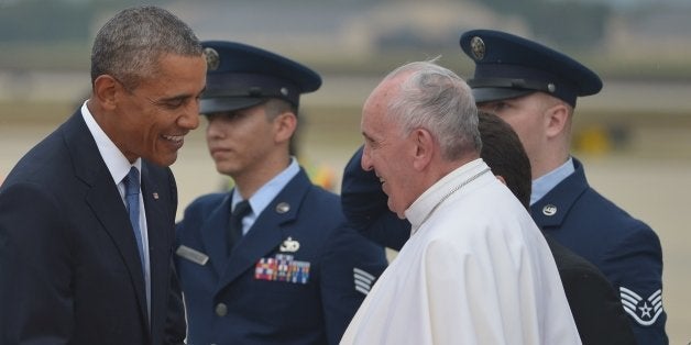 US President Barack Obama (L) greets Pope Francis (R) upon his arrival September 22, 2015 at Andrews Air Force Base in Maryland. AFP PHOTO/MANDEL NGAN (Photo credit should read MANDEL NGAN/AFP/Getty Images)