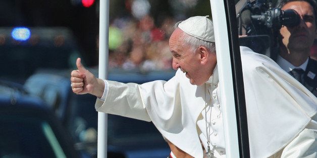WASHINGTON, DC - SEPTEMBER 23: Pope Francis leans out and waves to the crowd as he rides in a popemobile along a parade route around the National Mall on September 23, 2015 in Washington, DC. Thousands of people gathered near the Ellipse to catch of glimpse of Pope Francis after he addressed an audience of 15,000 invited guests on the South Lawn of the White House during an official arrival ceremony with President Barack Obama. The Pope began his first trip to the United States at the White House followed by a visit to St. Matthew's Cathedral, and will then hold a Mass on the grounds of the Basilica of the National Shrine of the Immaculate Conception. (Photo by Chip Somodevilla/Getty Images)