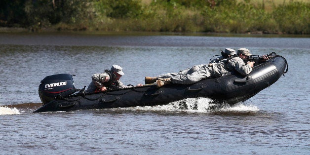 U.S. Army rangers demonstrates watercraft skills during a Army Ranger school graduation Friday, Aug. 21, 2015, in Fort Bennin