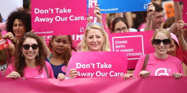 MANHATTAN, NEW YORK CITY, NEW YORK, UNITED STATES - 2015/09/29: Participants hold pink Planned Parenthood banner and signs. A