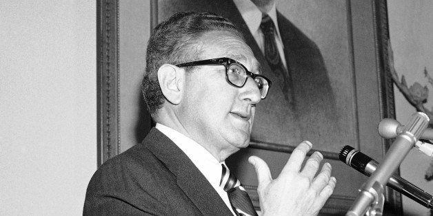 Secretary of State Henry Kissinger a member of the sponsoring committee of the Hubert H. Humphrey Institute of Public Affairs, reports on the progress of international fund raising efforts for the institute, at the Embassy of Iran in Washington on Friday, Jan. 27, 1978. In background is a portrait of the Shah of Iran. (AP Photo/Taylor)