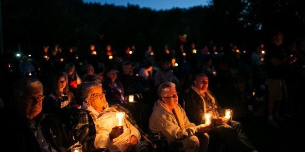 WINSTON, ORE. -- SATURDAY, OCTOBER 3, 2015: Community members hold a candlelight vigil during a memorial service called 'Prayers for Roseburg,' which is organized in response to the recent Umpqua community college mass shootings, at Riverbend Park in Winston, Ore., on Oct. 3, 2015. (Marcus Yam / Los Angeles Times via Getty Images)