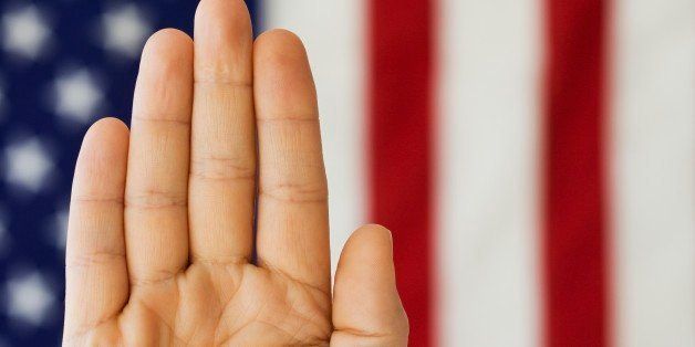 Man's hand up in front of American flag