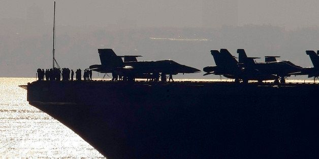 The nuclear powered aircraft carrier USS George H.W. Bush arrives for a of four-day stop in the harbour of Marseille, southern France, Saturday, Nov. 1, 2014. The vessel took part in the mission Enduring Freedom in Afghanistan and against the Islamic State group in Iraq. (AP Photo/Claude Paris)