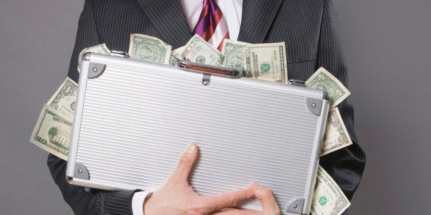 Caucasian business man with case of money
