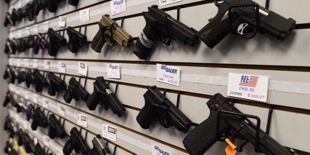 Handguns are displayed at the Ultimate Defense Firing Range and Training Center in St Peters, Missouri, some 20 miles (32 kilometers) west of Ferguson, on November 26, 2014. Paul Bastean, owner of the range, told AFP that business had grown as a result of anxiety about reaction to the jury announcement in the shooting death of 18-year-old Michael Brown. Typical sales of five to seven guns a day have risen to 20 to 30 in the last week, while gun-handling courses for November and December are fast selling out. Violence erupted in the St Louis, Missouri suburb for a second night on November 25 over the decision by a grand jury not to prosecute a white police officer for shooting dead Brown, an unarmed black teenager. AFP PHOTO/Jewel Samad (Photo credit should read JEWEL SAMAD/AFP/Getty Images)