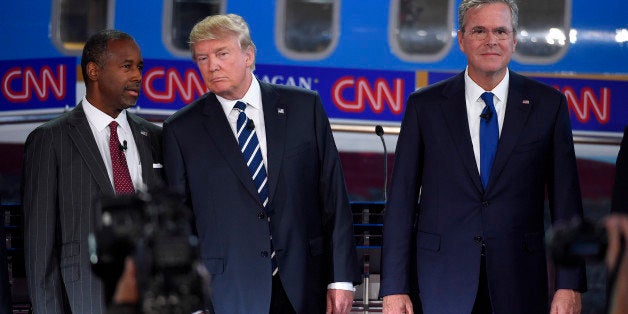 Republican presidential candidates, from left, Ben Carson, Donald Trump, and former Florida Gov. Jeb Bush pose for a group pi