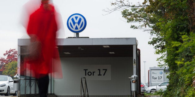 A VW employee enters the Volkswagen factory site through Gate 17 in Wolfsburg, Germany, Oct. 6, 2015. For Volkswagen, the cost of its cheating on emissions tests in the U.S. is likely to run into the tens of billions of dollars and prematurely end its long-sought status as the world's biggest carmaker. (Julian Stratenschulte/dpa via AP)