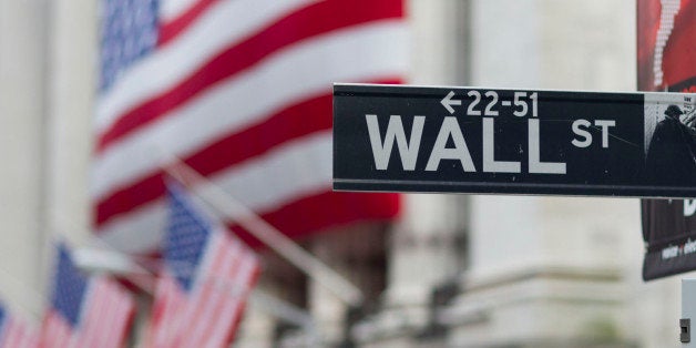 In this Aug. 8. 2011 photo, a Wall Street sign hangs near the New York Stock Exchange, in New York. Stocks tanked again Tuesd