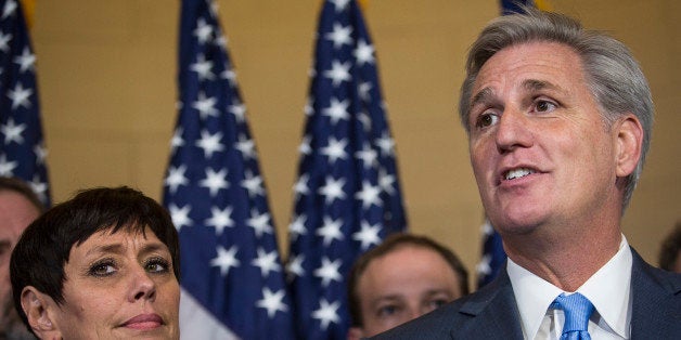 House Majority Leader Kevin McCarthy, a Republican from California, right, stands with his wife Judy McCarthy while speaking to the media on Capitol Hill in Washington, D.C., U.S., on Thursday, Oct. 8, 2015. McCarthy dropped out of the race for U.S. House speaker on the day his party was poised to nominate him to replace John Boehner, as an internal Republican feud erupted into open warfare on Capitol Hill. Photographer: Drew Angerer/Bloomberg via Getty Images 