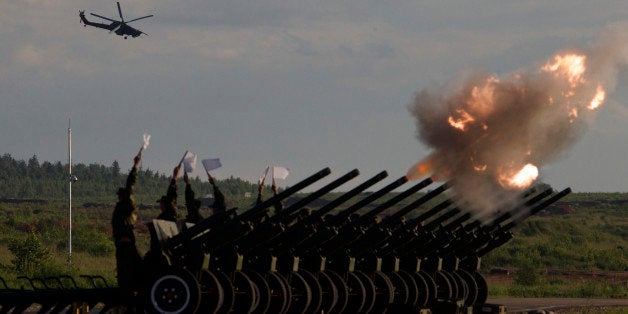 Russian Army's MI-28 attack helicopter flies as salute cannons fire during a show at a shooting range in Alabino, outside of Moscow, Russia, on Tuesday, June 16, 2015. Russiaâs military this year alone will receive over 40 new intercontinental ballistic missiles capable of piercing any missile defences, President Vladimir Putin said Tuesday in a blunt reminder of the nationâs nuclear might amid tensions with the West over Ukraine. (AP Photo/Ivan Sekretarev)