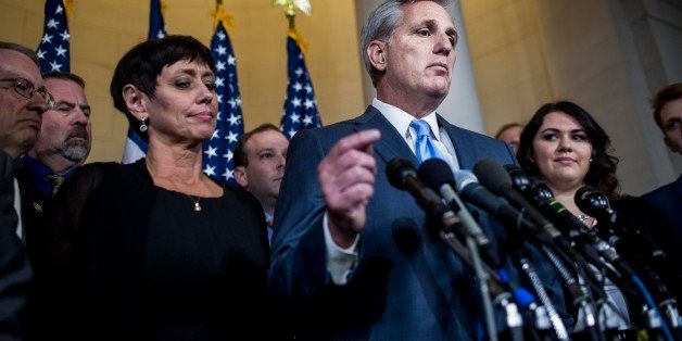 WASHINGTON, DC - OCTOBER 8: House Majority Leader Kevin McCarthy, with wife Judy McCarthy, left and surrounded by family, friends and staff, speaks to journalists when leaving the Republican House Leadership conference meeting and stepping away from running for the House Speakership, on Capitol Hill Thursday, October 8, 2015. (Photo by Melina Mara/The Washington Post via Getty Images)
