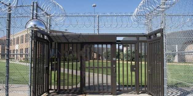 The entrance to El Reno Federal Correctional Institution in El Reno, Oklahoma, July 16, 2015, as US President Barack Obama arrives for a visit. Obama is the first sitting US President to visit a federal prison, in a push to reform one of the most expensive and crowded prison systems in the world. AFP PHOTO / SAUL LOEB (Photo credit should read SAUL LOEB/AFP/Getty Images)