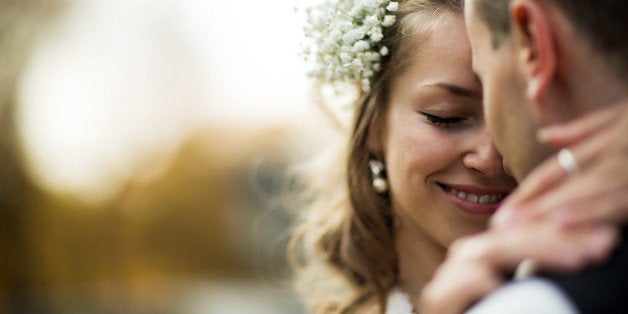 beautiful couple enjoying embrace of each other and tenderly smiling