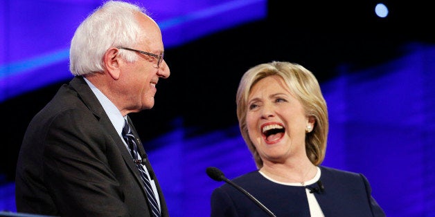 Sen. Bernie Sanders, of Vermont,, left, and Hillary Rodham Clinton laugh during the CNN Democratic presidential debate, Tuesday, Oct. 13, 2015, in Las Vegas. (AP Photo/John Locher)