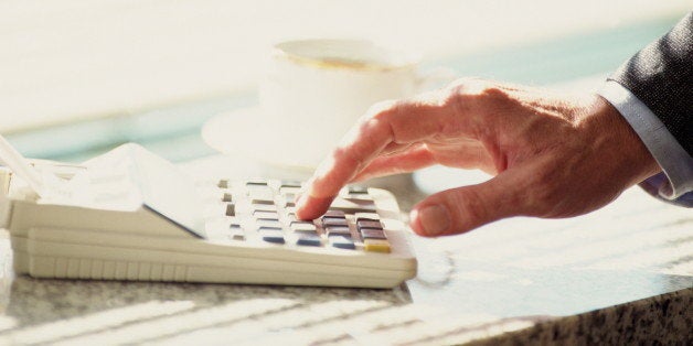 Man's hand using calculator