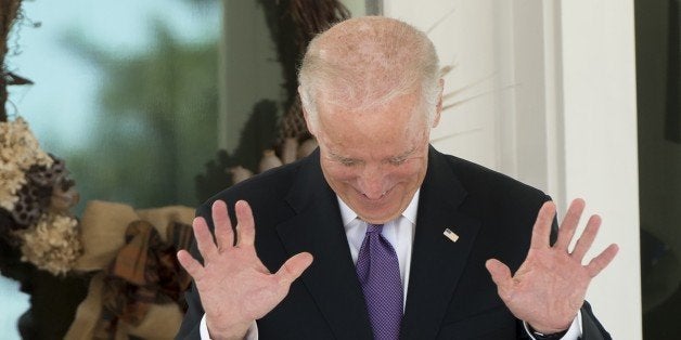 US Vice President Joe Biden reacts as reporters shout questions asking if he has made a decision on whether to run for Presid