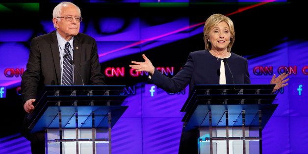 Hillary Rodham Clinton, right, speaks as Sen. Bernie Sanders, of Vermont, looks on during the CNN Democratic presidential debate Tuesday, Oct. 13, 2015, in Las Vegas. (AP Photo/John Locher)