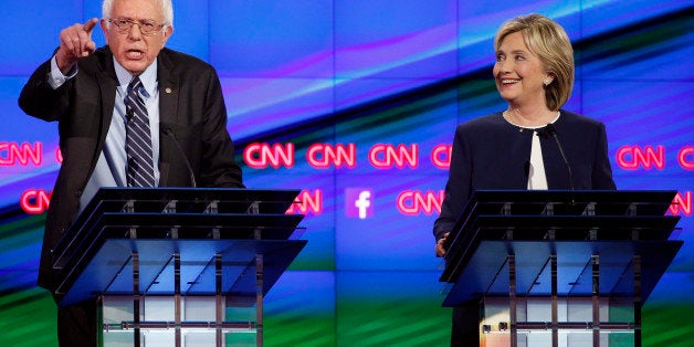 Sen. Bernie Sanders, of Vermont, left, speaks as Hillary Rodham Clinton looks on during the CNN Democratic presidential debate Tuesday, Oct. 13, 2015, in Las Vegas. (AP Photo/John Locher)