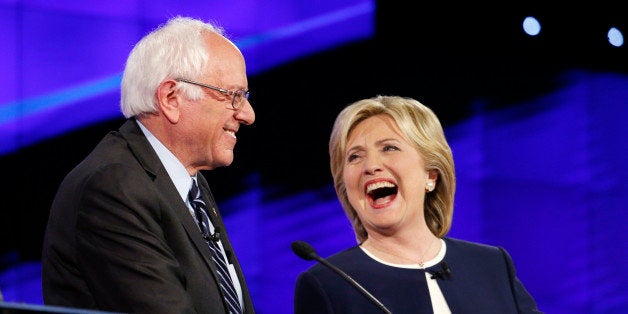 Sen. Bernie Sanders, of Vermont, left, and Hillary Rodham Clinton laugh during the CNN Democratic presidential debate Tuesday, Oct. 13, 2015, in Las Vegas. (AP Photo/John Locher)