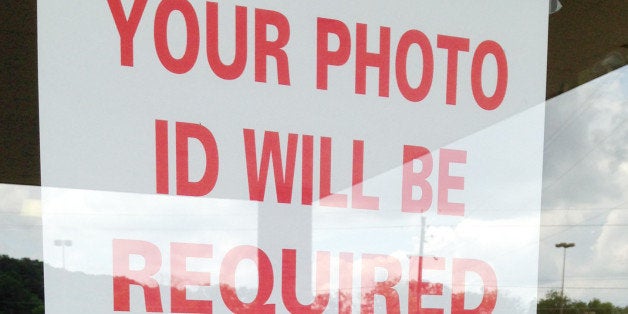A "no guns" hangs on the door of a voting precinct in Alabaster, Ala., on Tuesday, June 3, 2014. With a runoff election sched