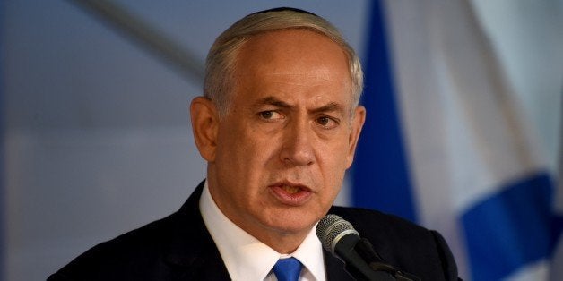 Israeli Prime Minister Benjamin Netanyahu speaks at a memorial service marking the 20th anniversary of the assassination of late prime minister Yitzhak Rabin in the Mt. Herzl Cemetery in Jerusalem, on October 26, 2015. Rabin was assassinated by an Israeli right-wing extremist who opposed his concessions for peace with the Palestinians. AFP PHOTO / POOL / DEBBIE HILL (Photo credit should read DEBBIE HILL/AFP/Getty Images)