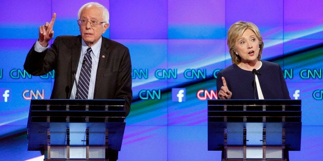 Hillary Rodham Clinton, right, and Sen. Bernie Sanders, of Vermont, speak during the CNN Democratic presidential debate Tuesd