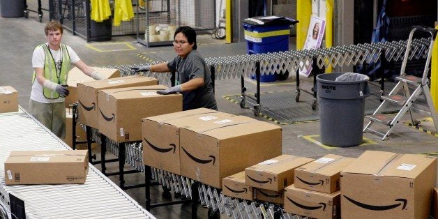 In this Nov. 16, 2009 photo, Stephen Guymon, left, of Twin Falls, Idaho, and Sanferd Glasses, of Kayenta, Ariz., separate packed boxes for final shipping inside the 800,000 sq. ft. Amazon.com warehouse in Goodyear, Ariz. (AP Photo/Ross D. Franklin)