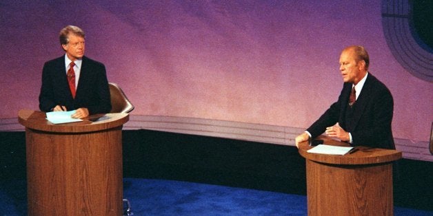 President Gerald Ford speaks as Jimmy Carter listens during the first of three televised debates in September 23, 1976, held