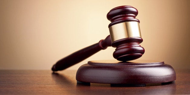 brown gavel on the table on a brown background